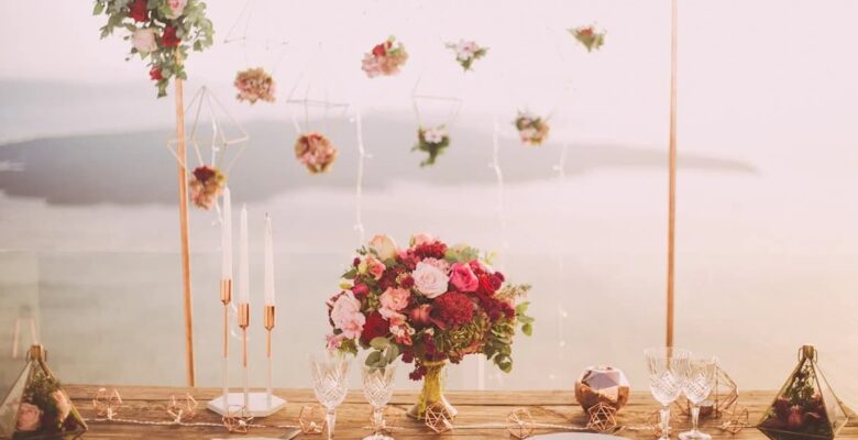 Elegant wedding table setting with floral centerpiece and hanging flowers