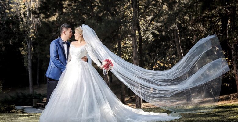 Bride and groom against a background of trees